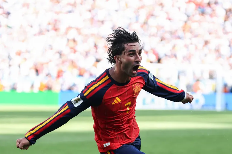 Footballer celebrating on the pitch during an international club match
